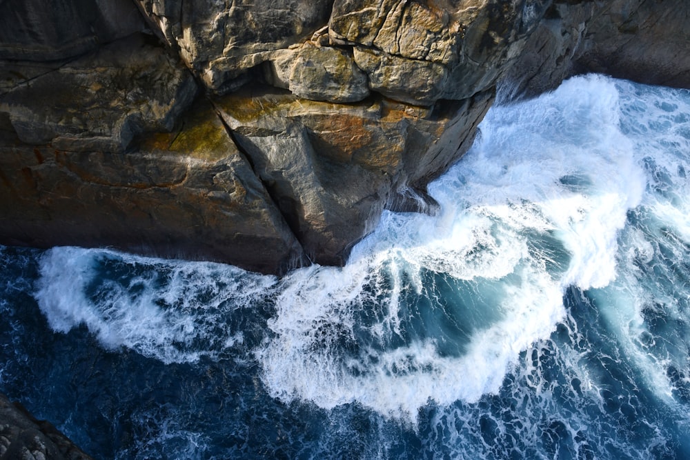 an aerial view of the ocean and cliffs
