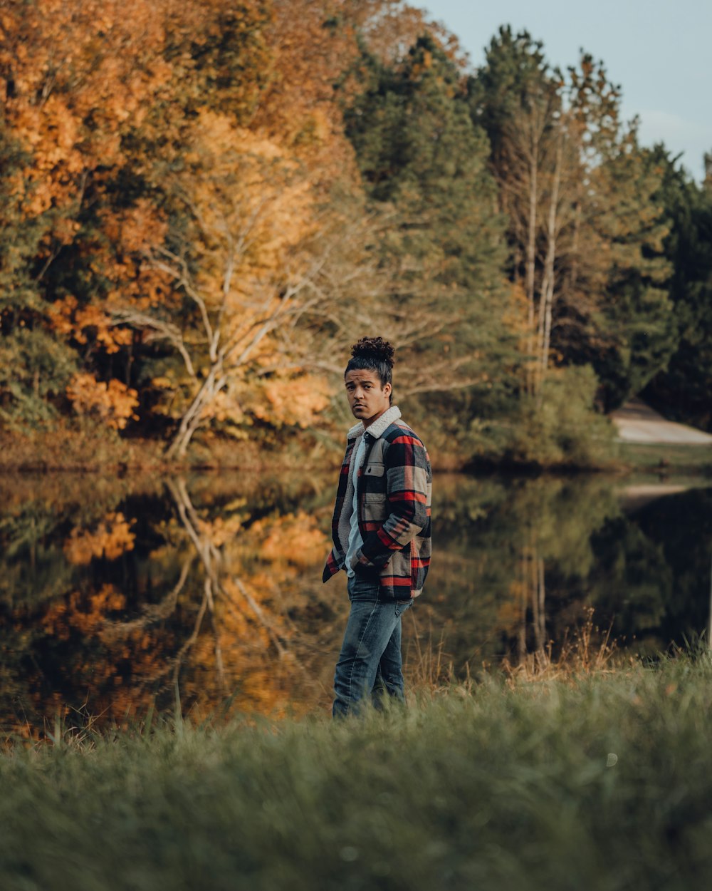 a man standing in front of a body of water