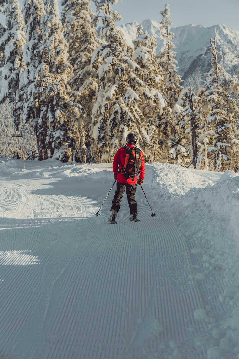 a man riding skis down a snow covered slope