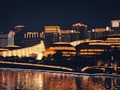 A futuristic cityscape at night with glowing blue lights reflecting technology themes.