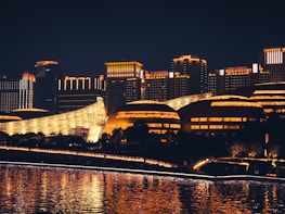 A futuristic cityscape at night with glowing blue lights reflecting technology themes.