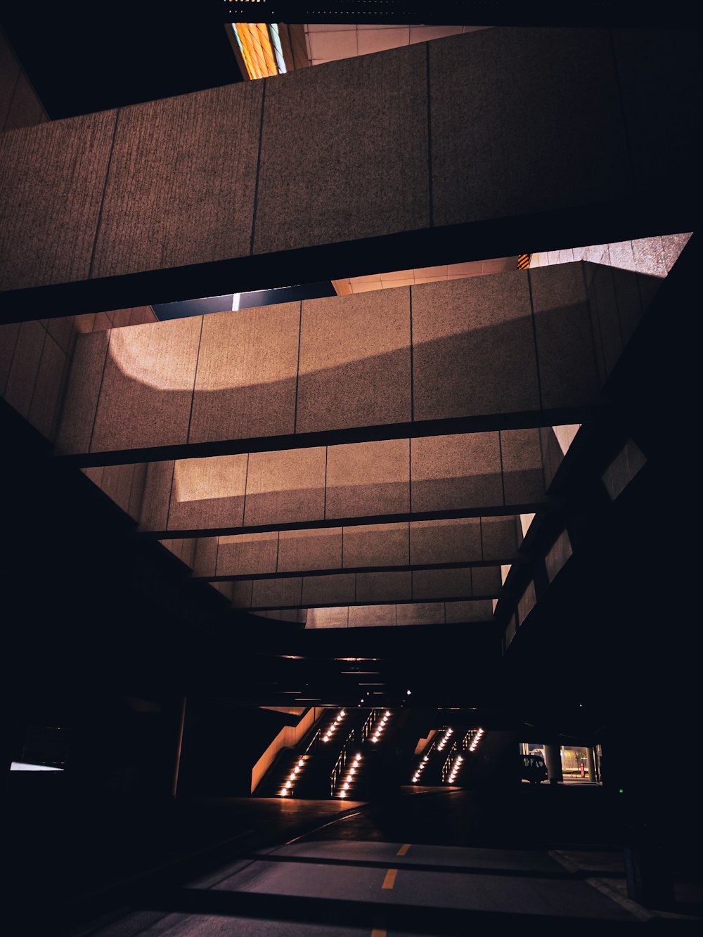 an empty parking garage with lights shining on the ceiling