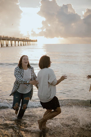 a couple of people that are standing in the water