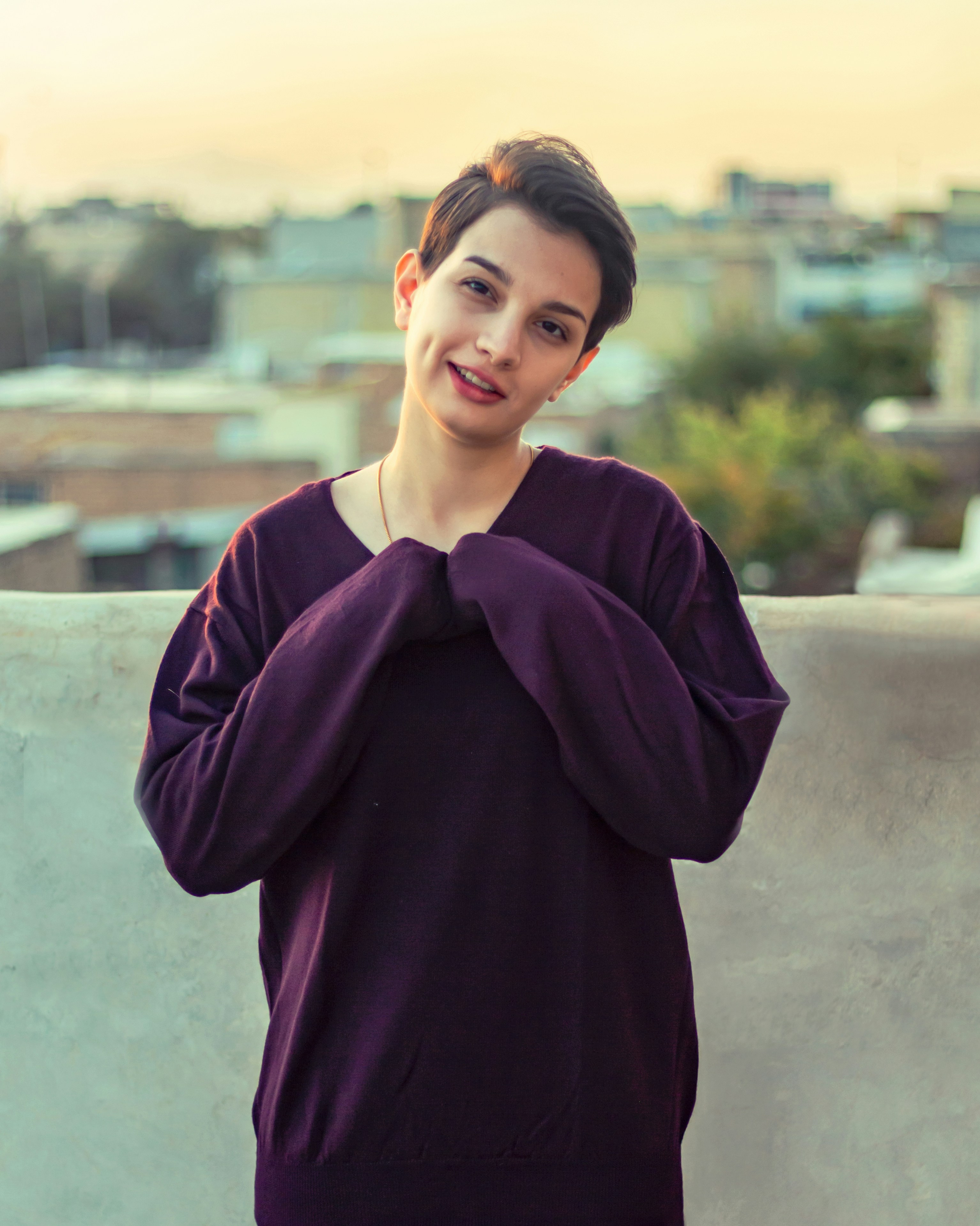 a woman standing on top of a cement wall
