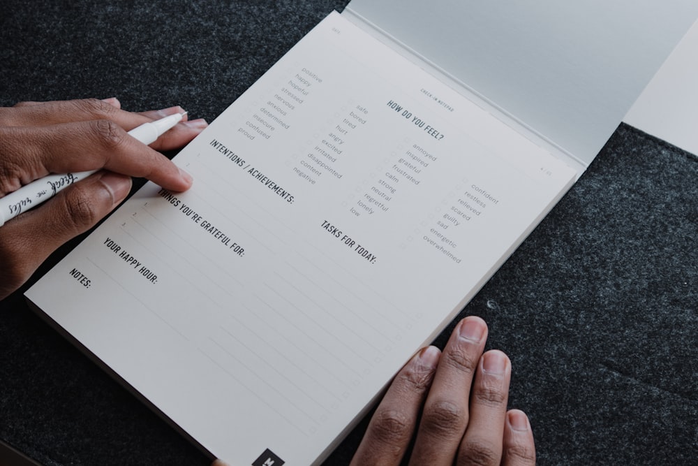 a person writing on a piece of paper