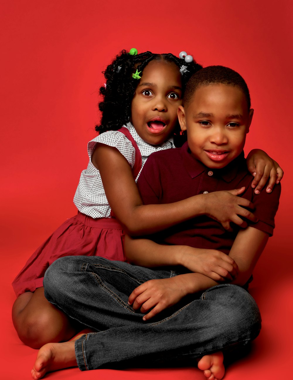 a couple of kids that are sitting on the ground