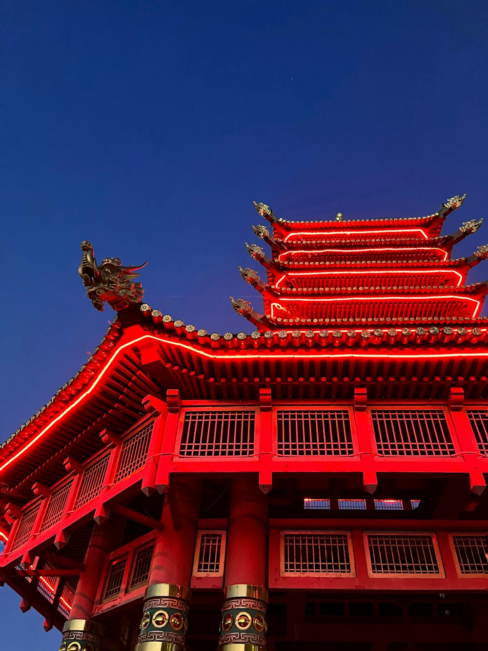a tall red building with a sky background