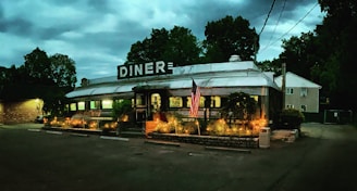 A cozy roadside diner bathed in warm sunset light, inviting travelers to pause and connect.