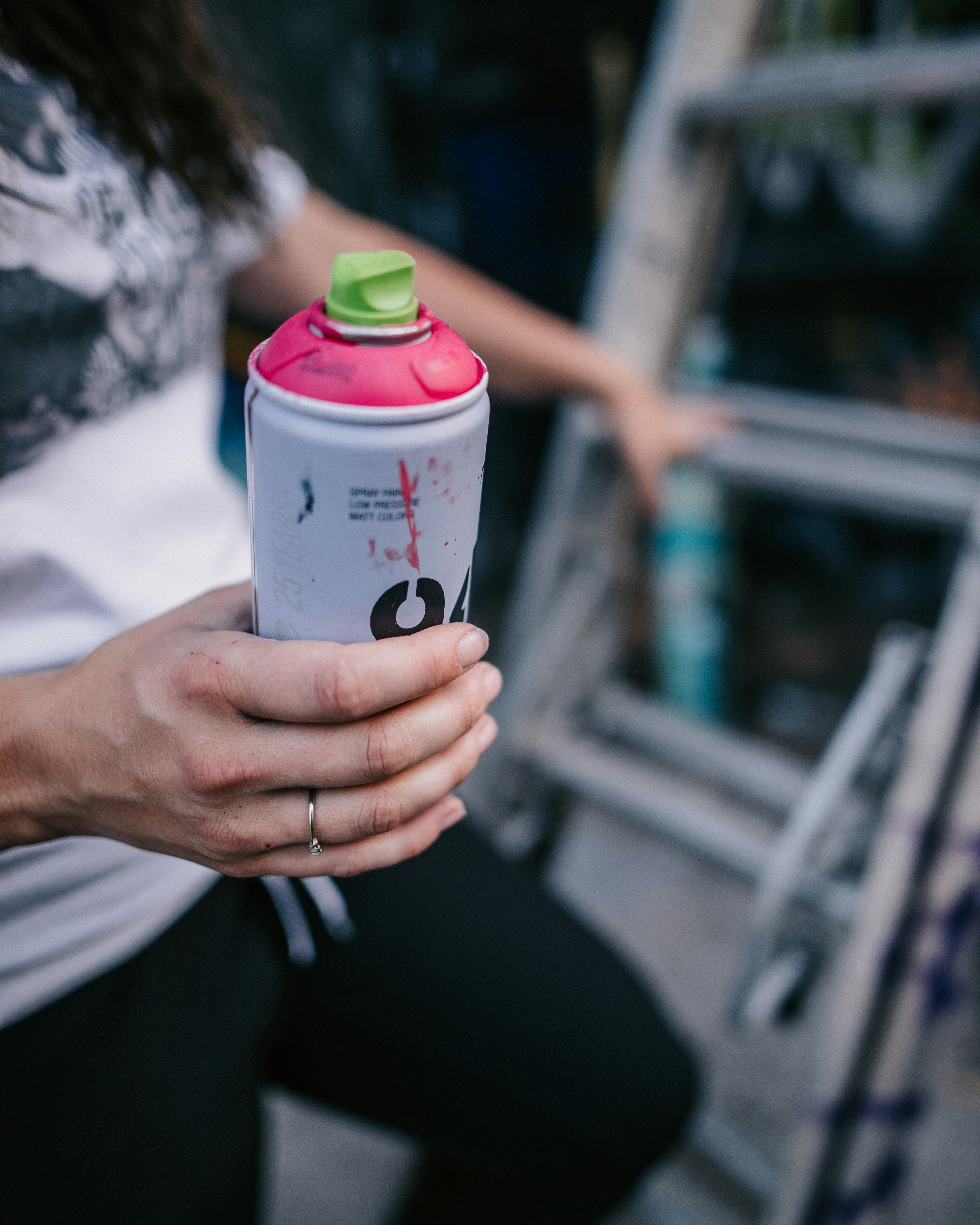 a woman holding a pink and green water bottle