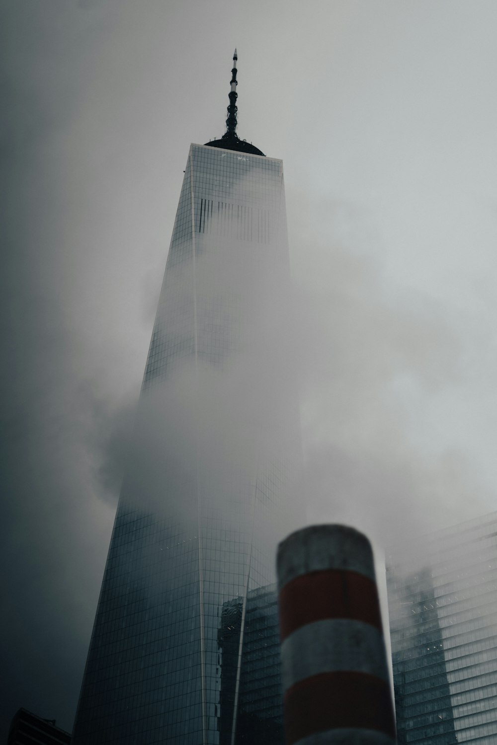 a very tall building with a lot of clouds in front of it