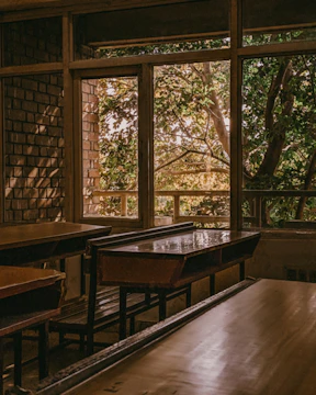 A serene classroom setting with empty desks bathed in soft natural light