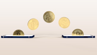 a bunch of coins flying out of a cell phone