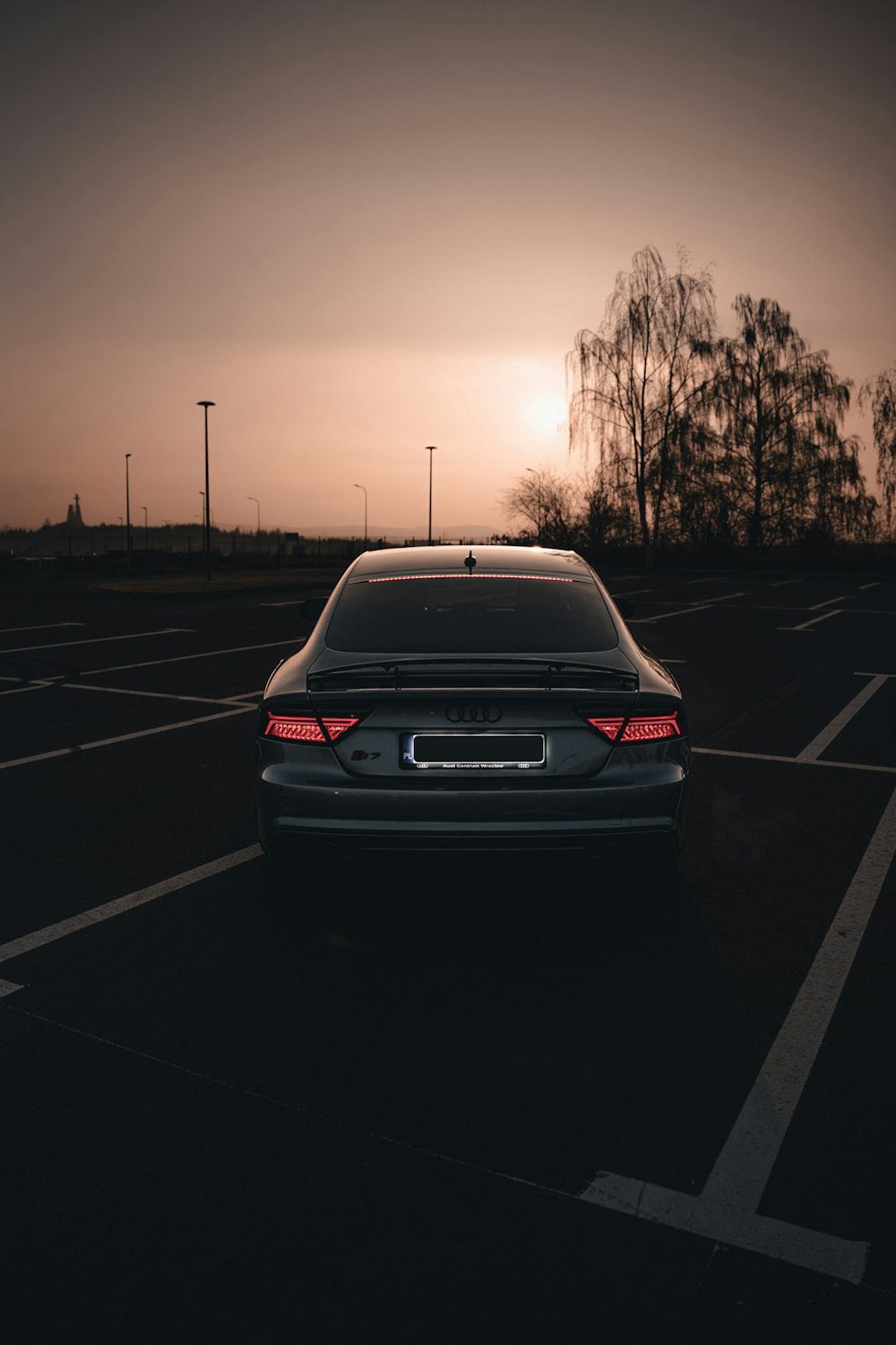 a car parked in a parking lot at sunset