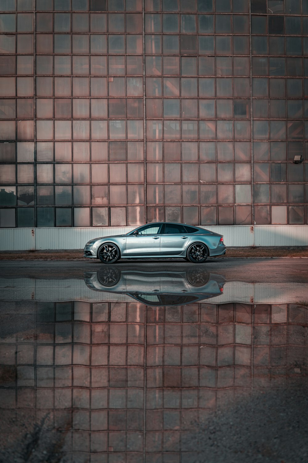 a silver car parked in front of a building