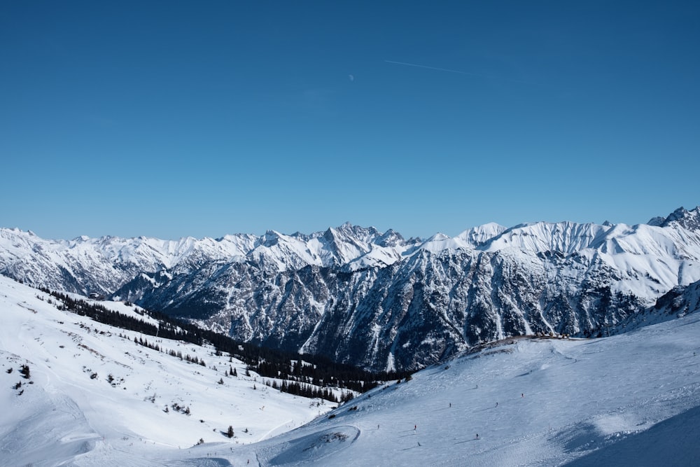 a view of a mountain range from a ski slope