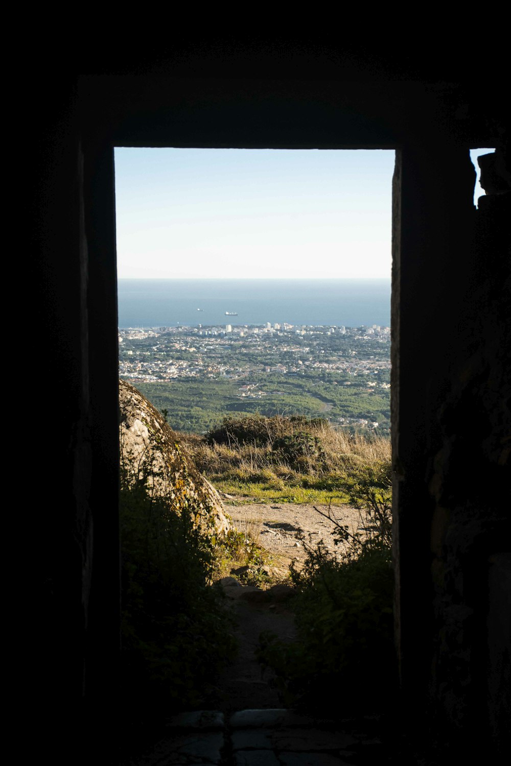 an open door leading to a view of a city