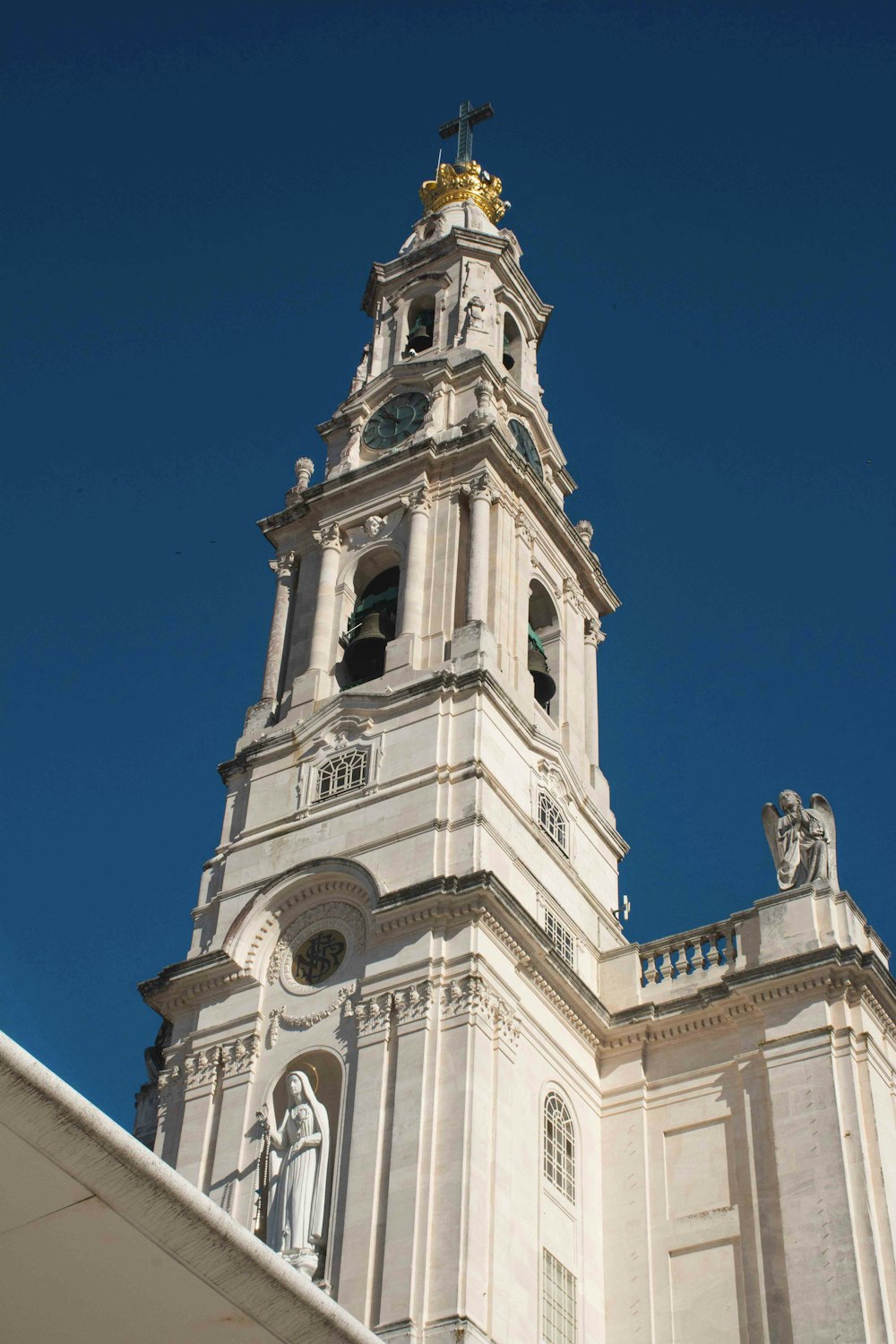 a tall white building with a clock on it's side