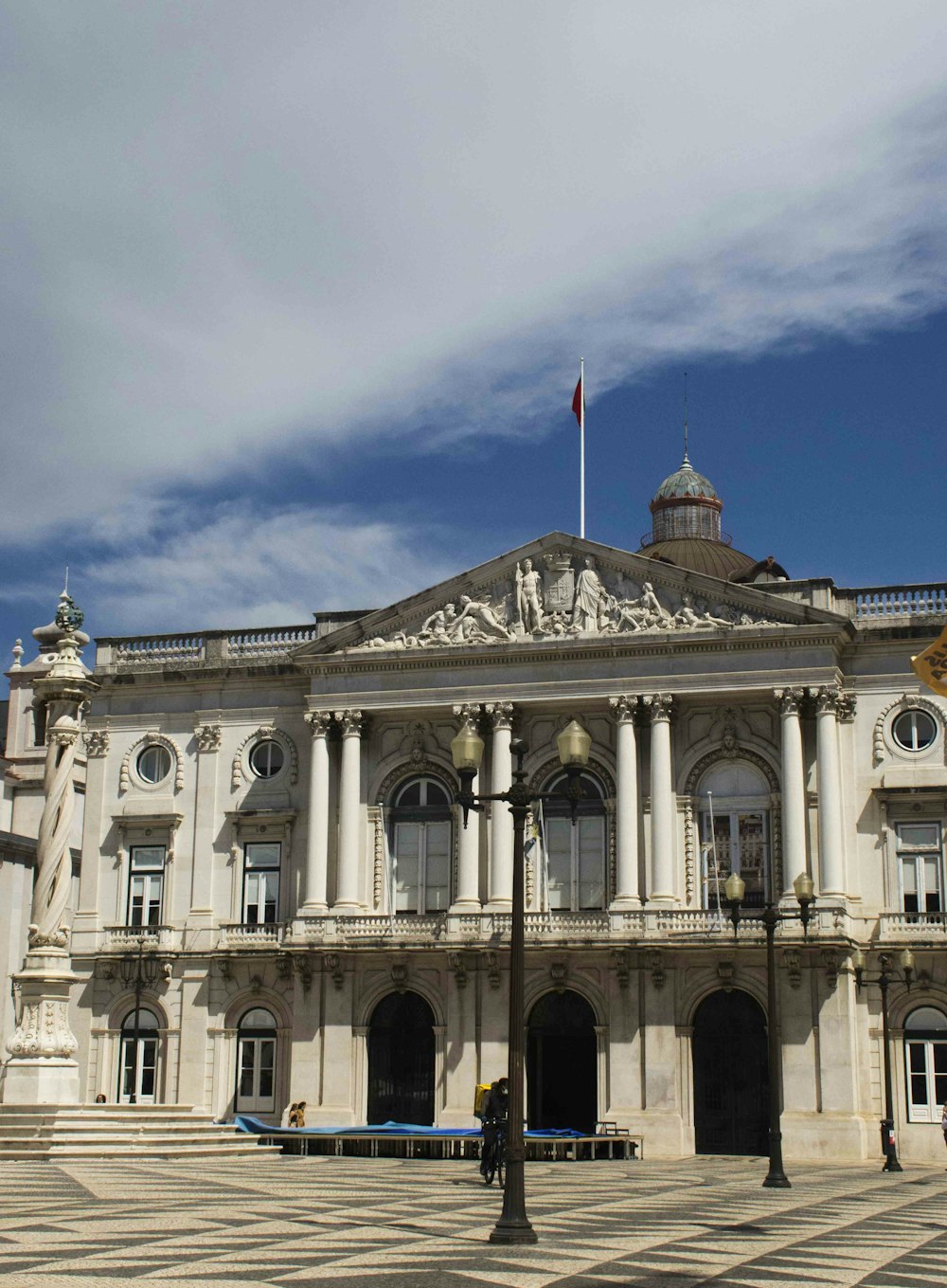 a large white building with a flag on top of it