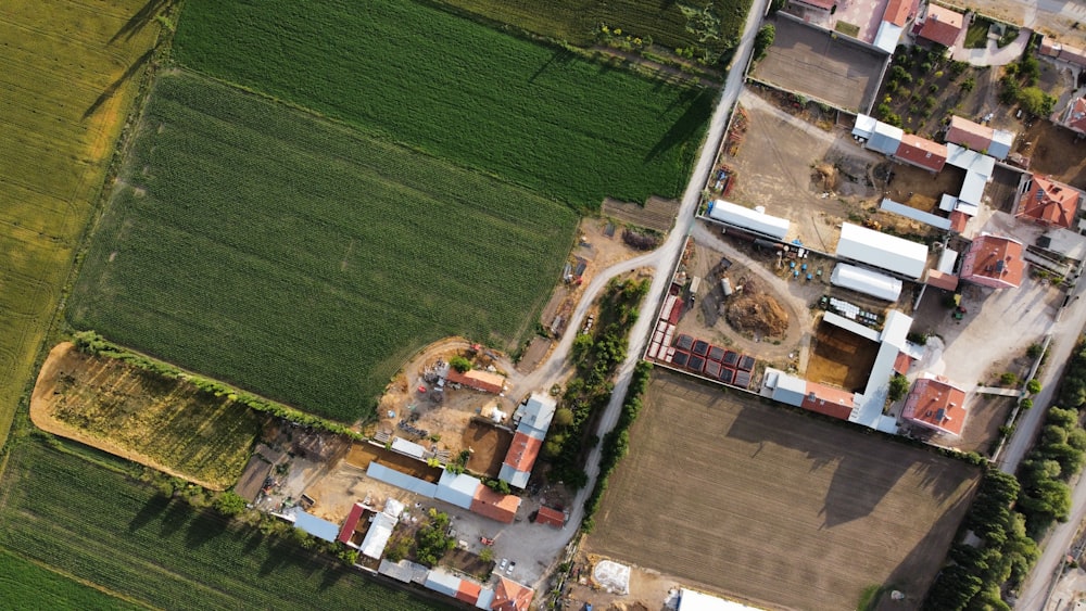 an aerial view of a farm and a road