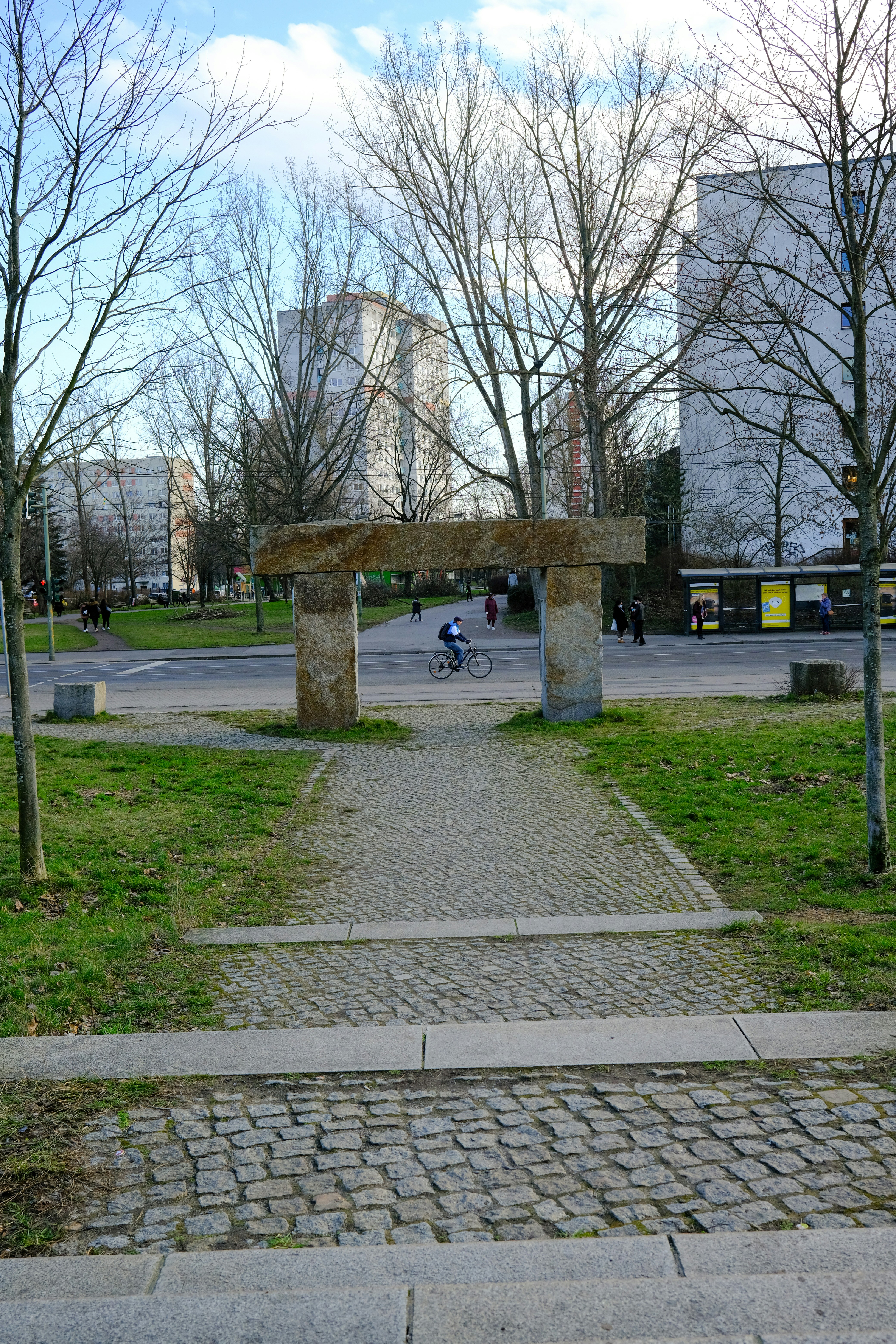 a person riding a bike on a path in a park