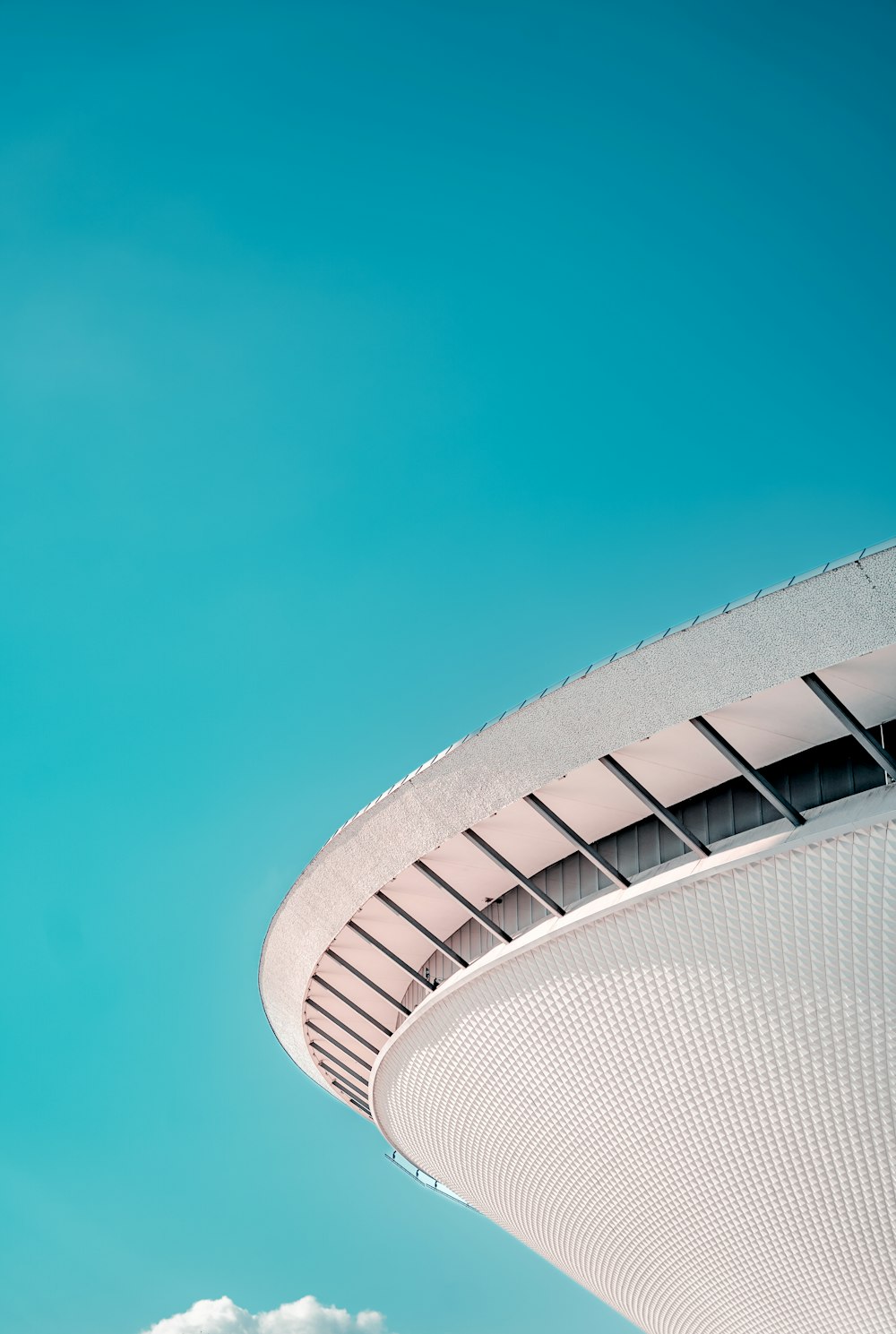 a plane flying in the sky over a building