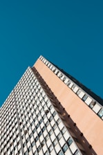 a tall building with lots of windows against a blue sky