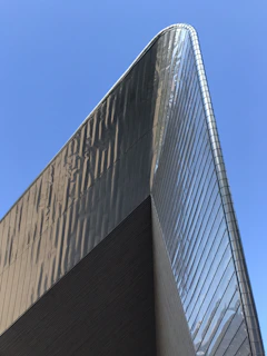 Finished commercial building showcasing sleek metal framework under clear blue sky
