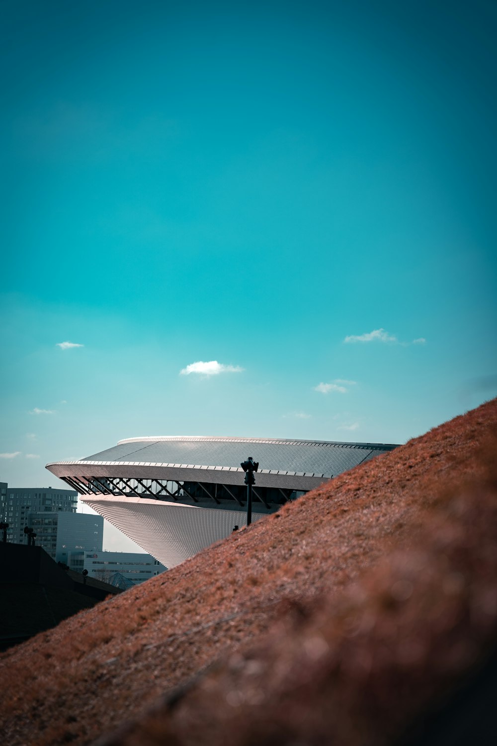 a man standing on top of a hill next to a building