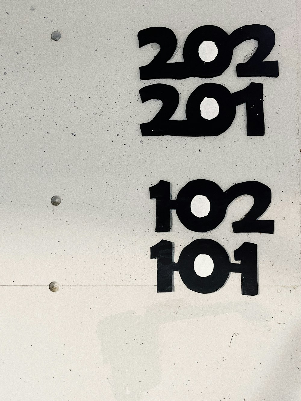the numbers are written on the side of a building