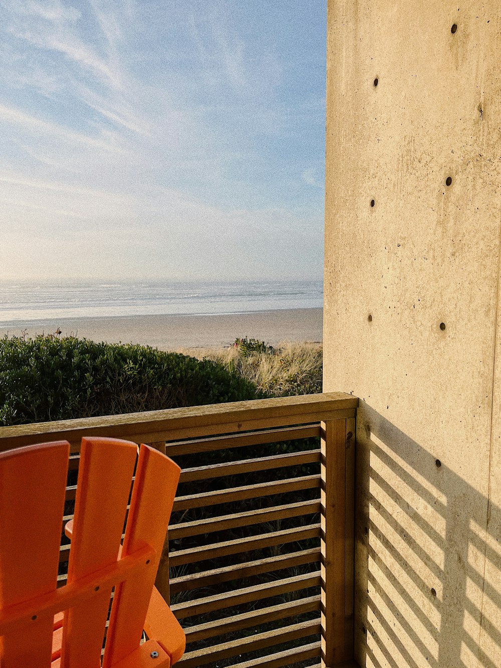 a couple of orange chairs sitting on top of a balcony