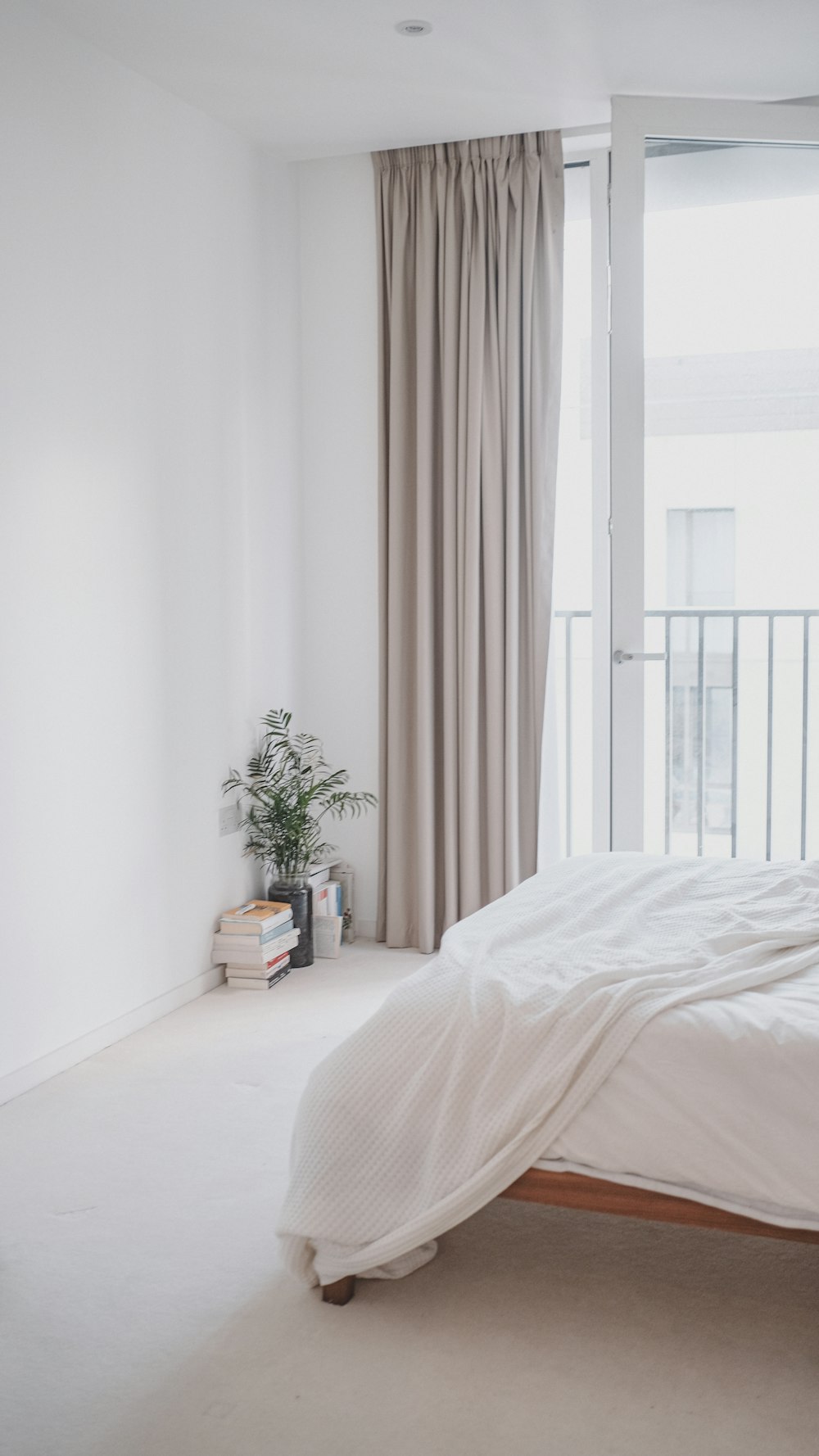 a bedroom with a large bed and a balcony