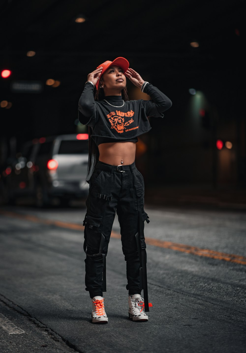 a woman in a crop top and cargo pants