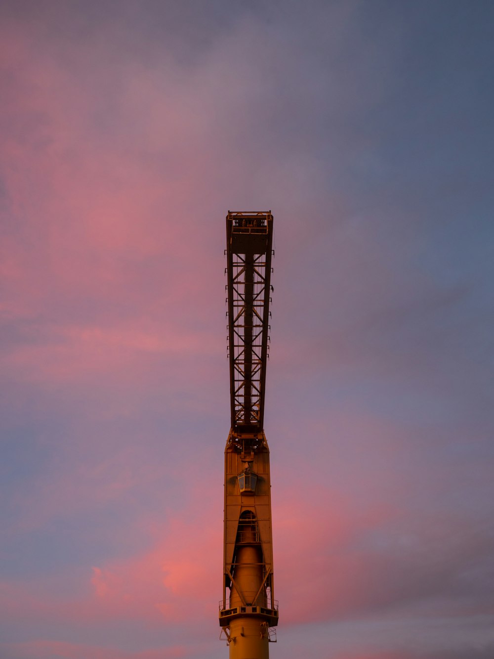 a large crane sitting on top of a metal pole