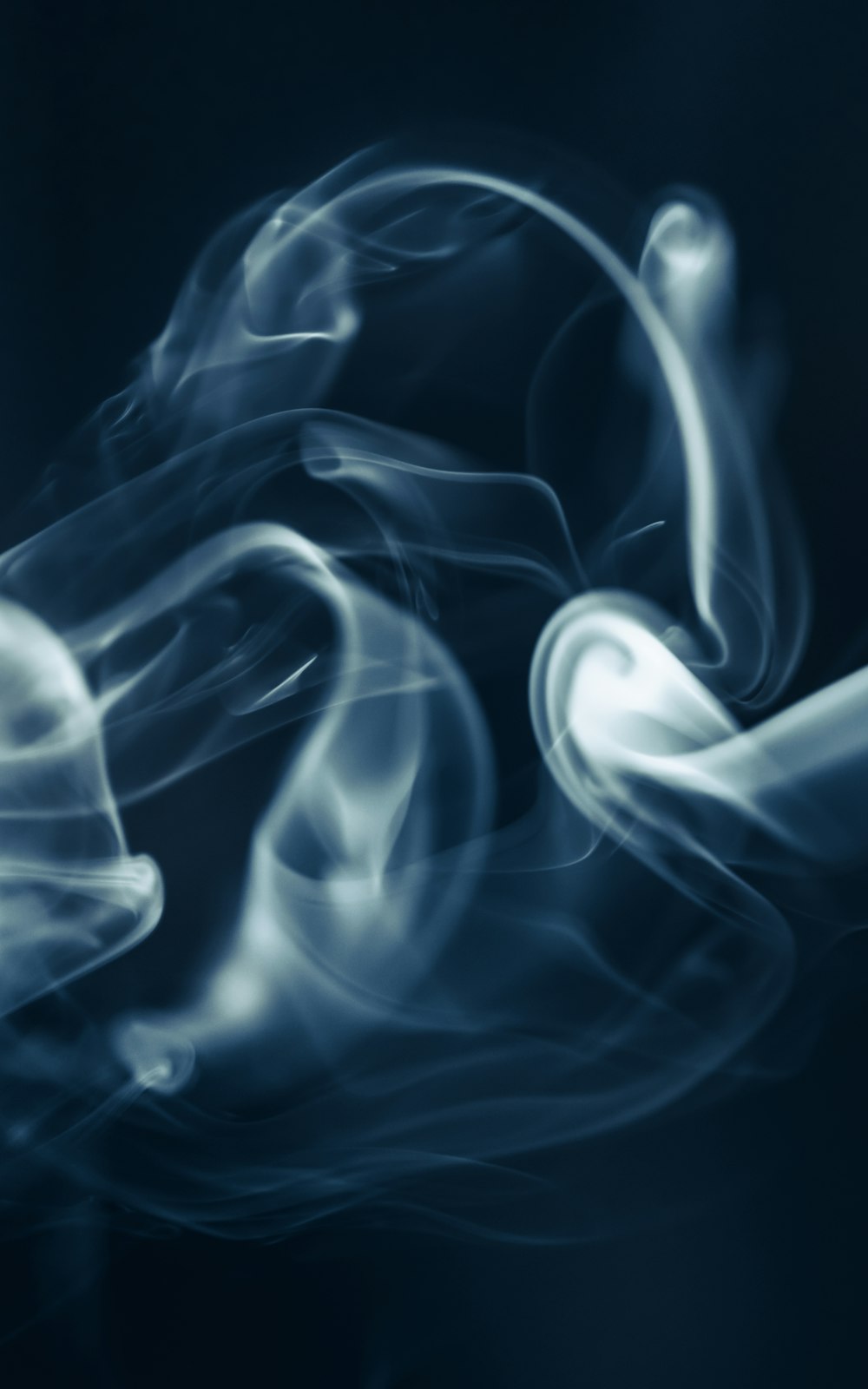 a blue and white smoke texture on a black background