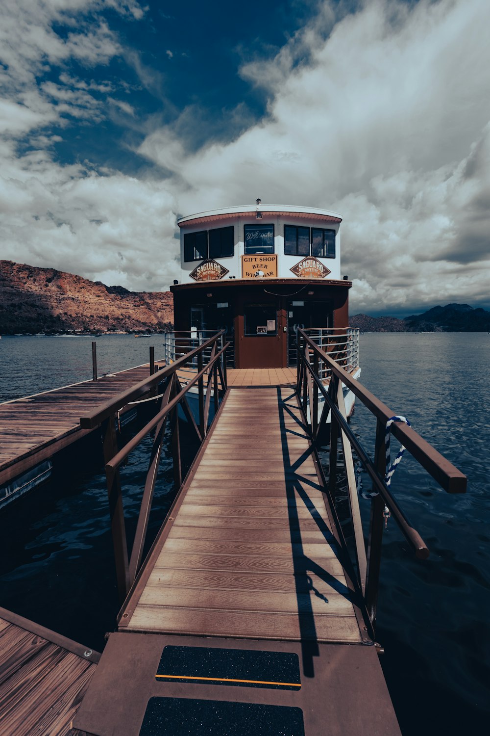 a boat docked at a pier on a lake