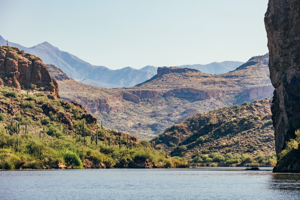 a body of water surrounded by mountains and trees