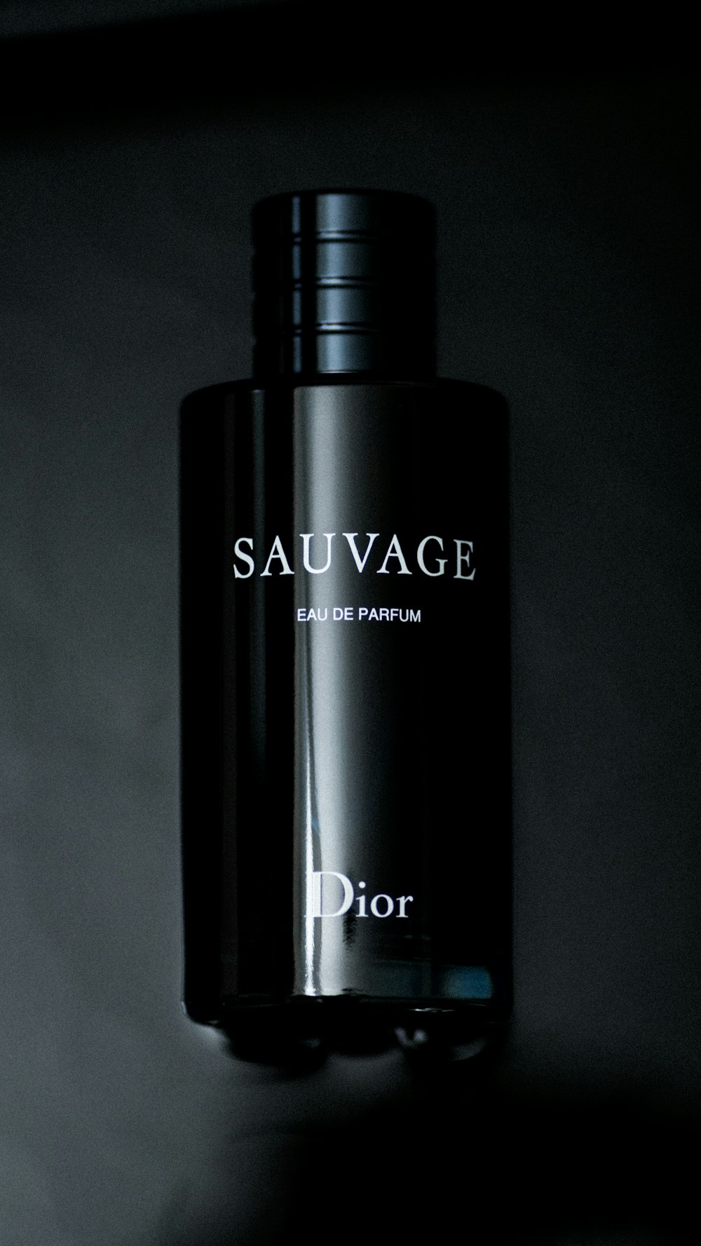 a bottle of dior sauvage on a wall