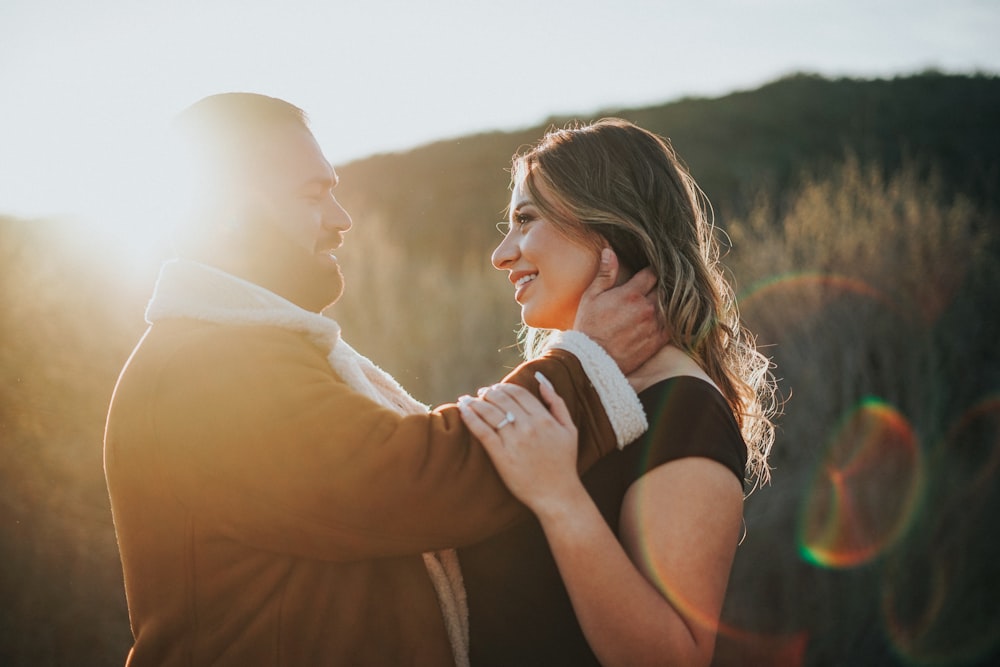 a man and a woman standing close to each other