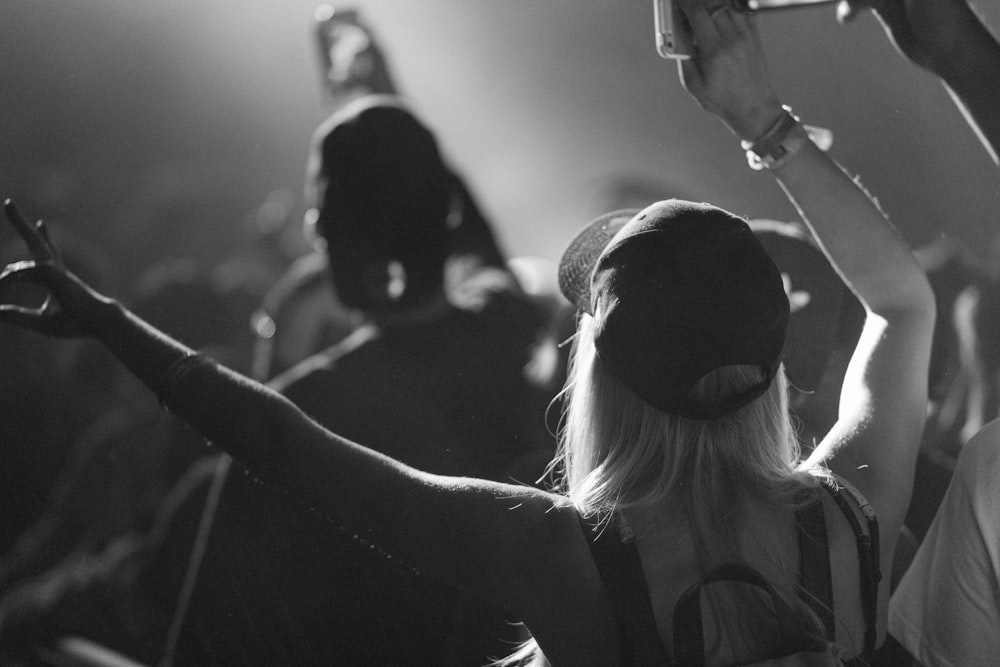 a black and white photo of a group of people at a concert