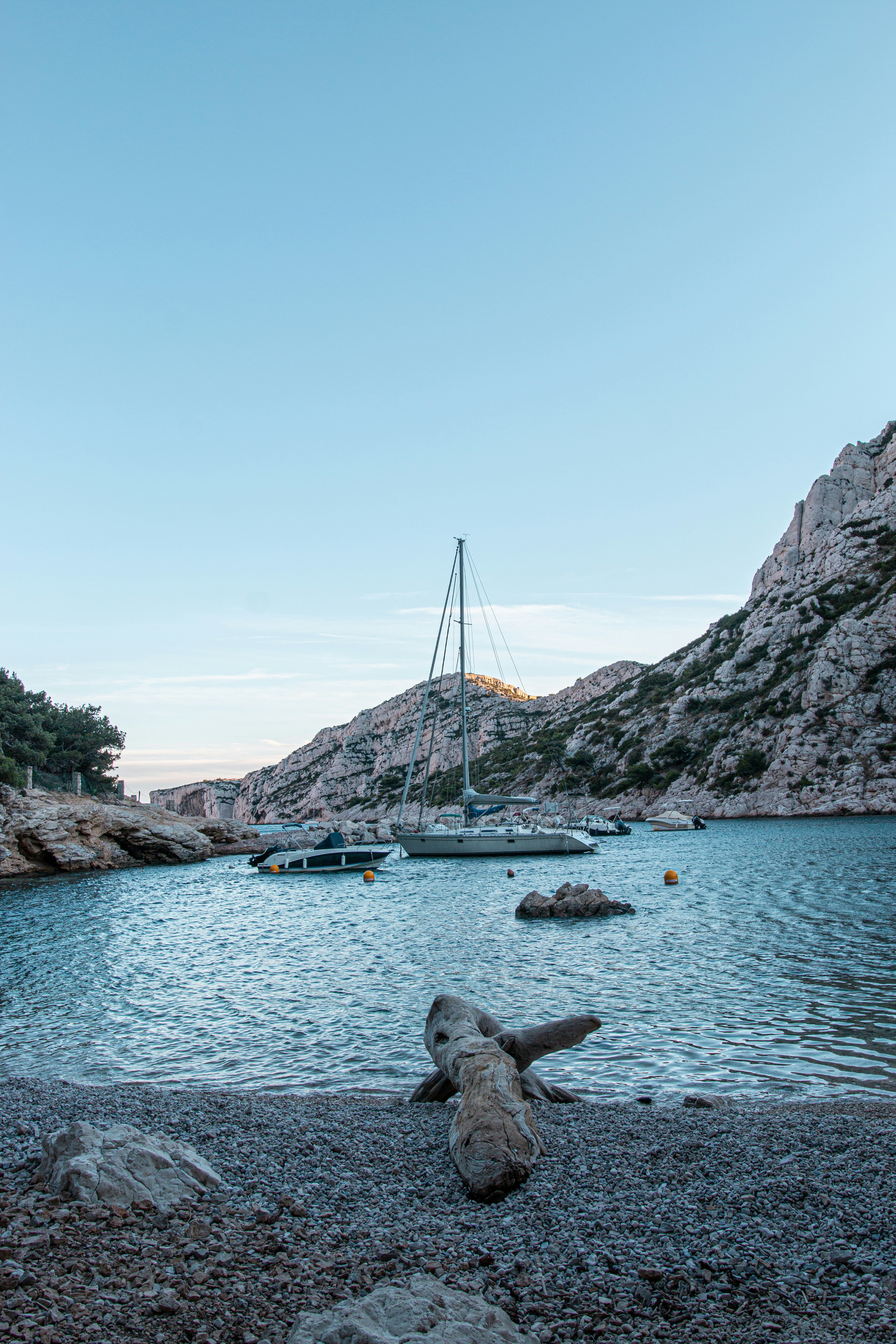 a boat is in the water near a rocky shore