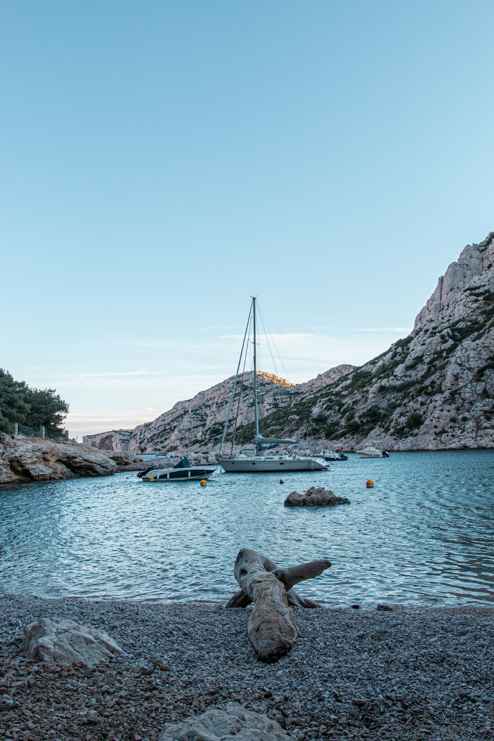 a boat is in the water near a rocky shore