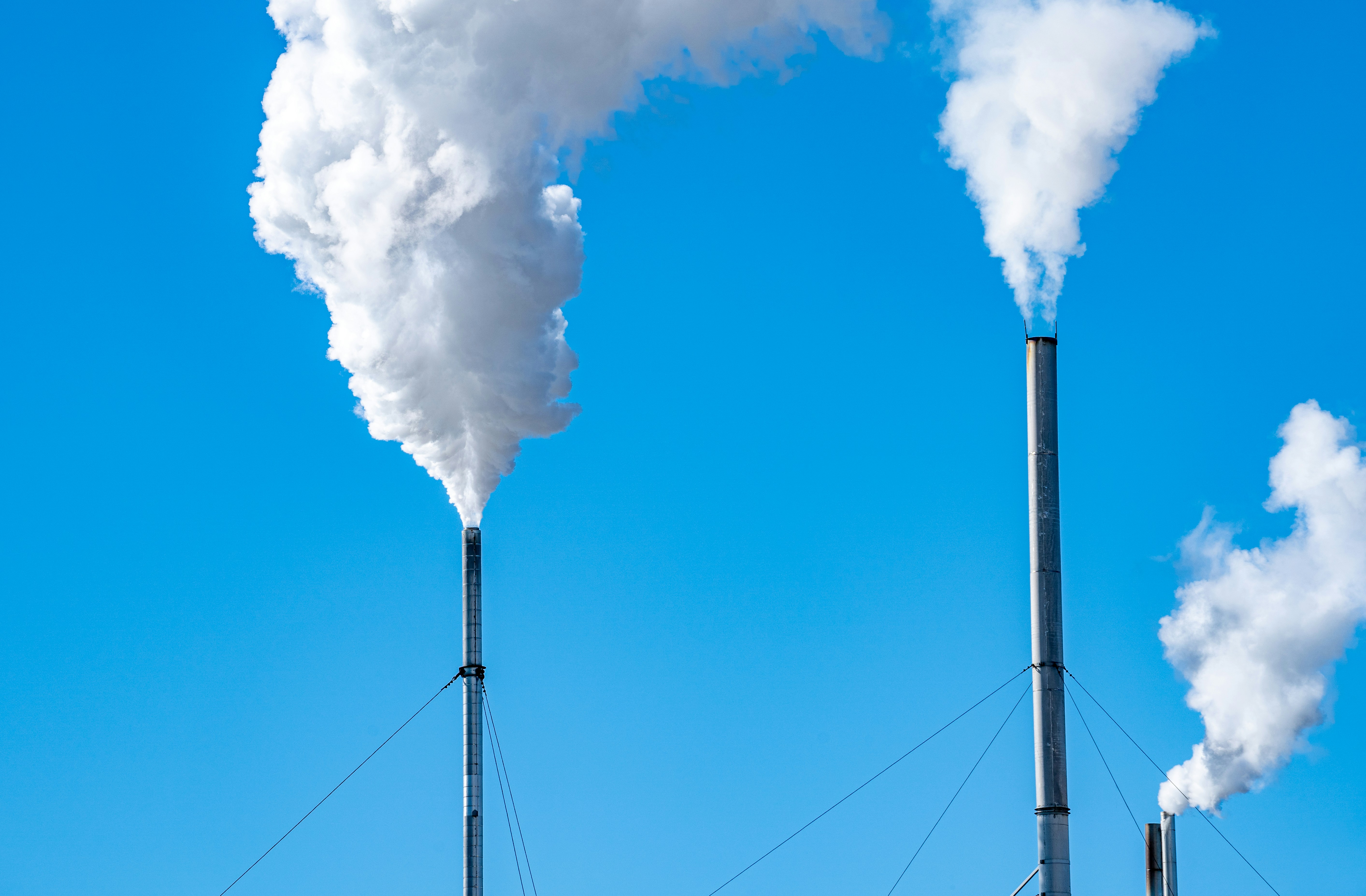 Smokestacks emitting pollution, representing industrial carbon emissions.