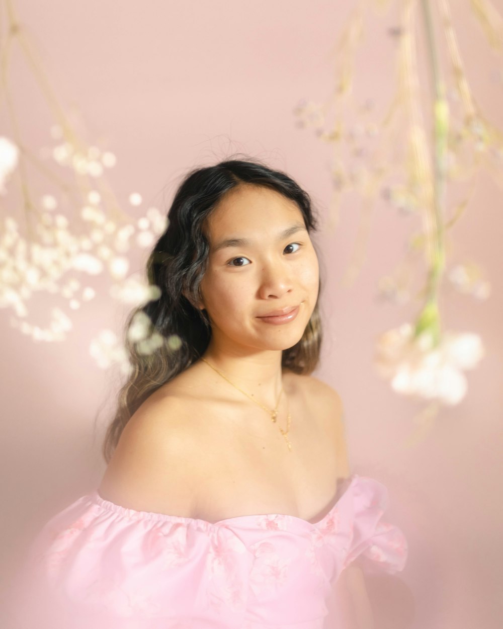 a woman in a pink dress posing for a picture