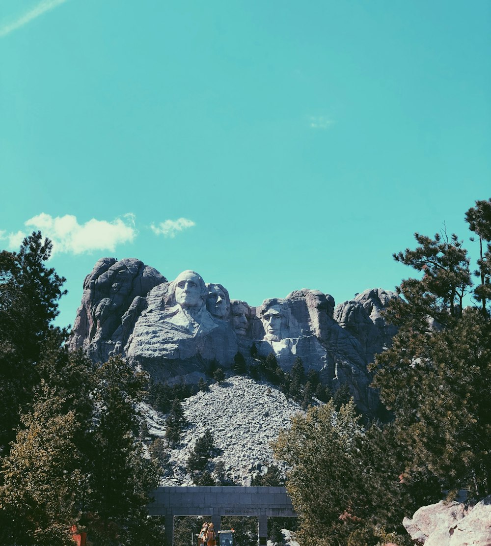 a group of people standing in front of a mountain