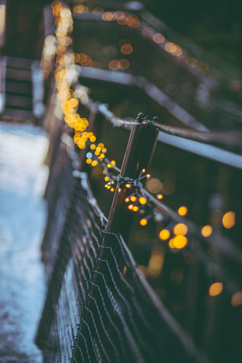 a close up of a fence with lights on it