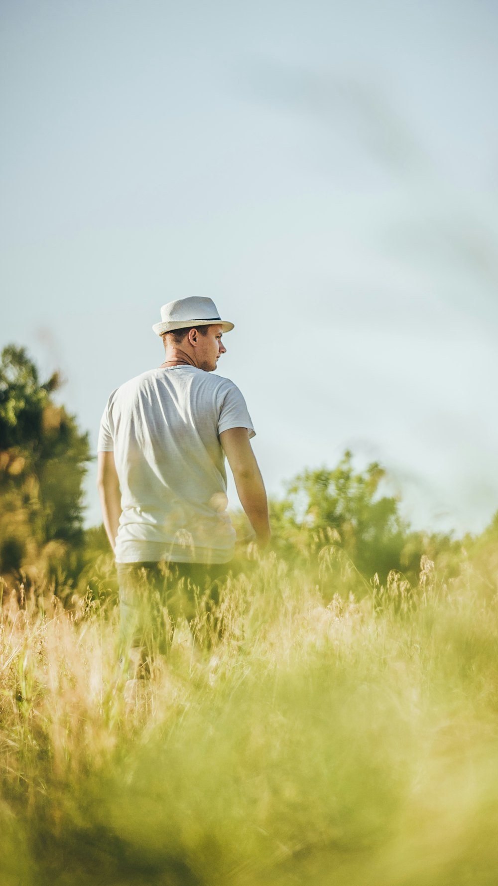 a man standing in a field of tall grass