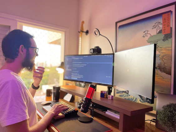Portrait of Marek Gellermann in a minimalist modern workspace with warm natural light.