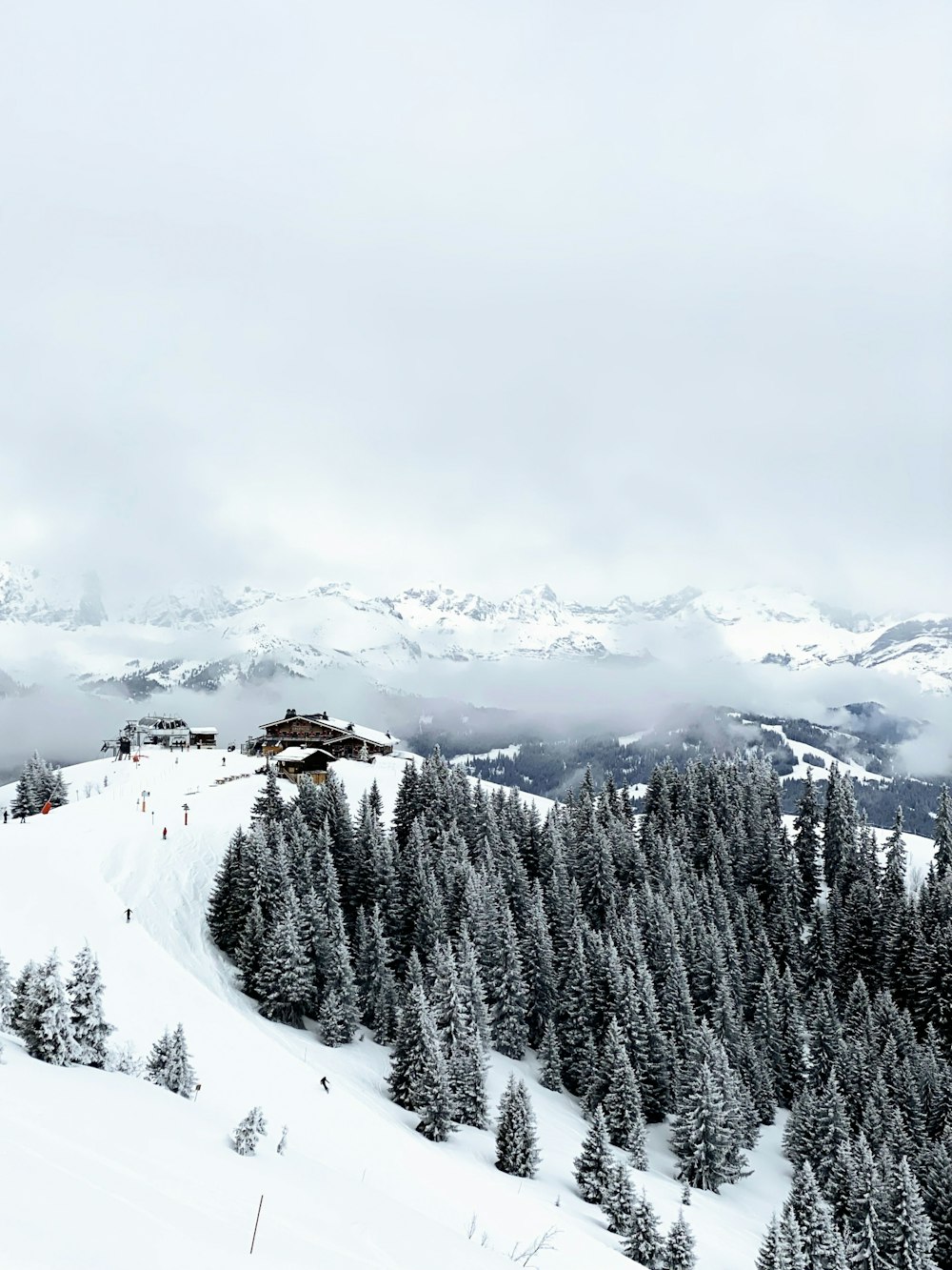 a person riding skis on top of a snow covered slope