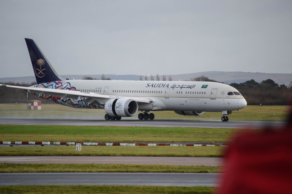 a large passenger jet taking off from an airport runway