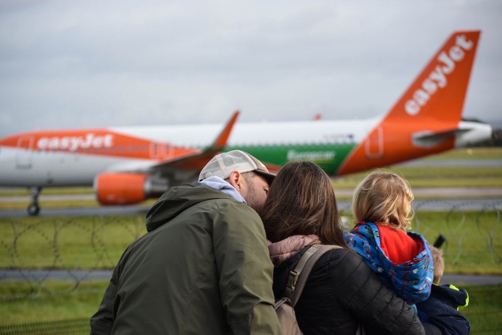 a group of people standing in front of an airplane